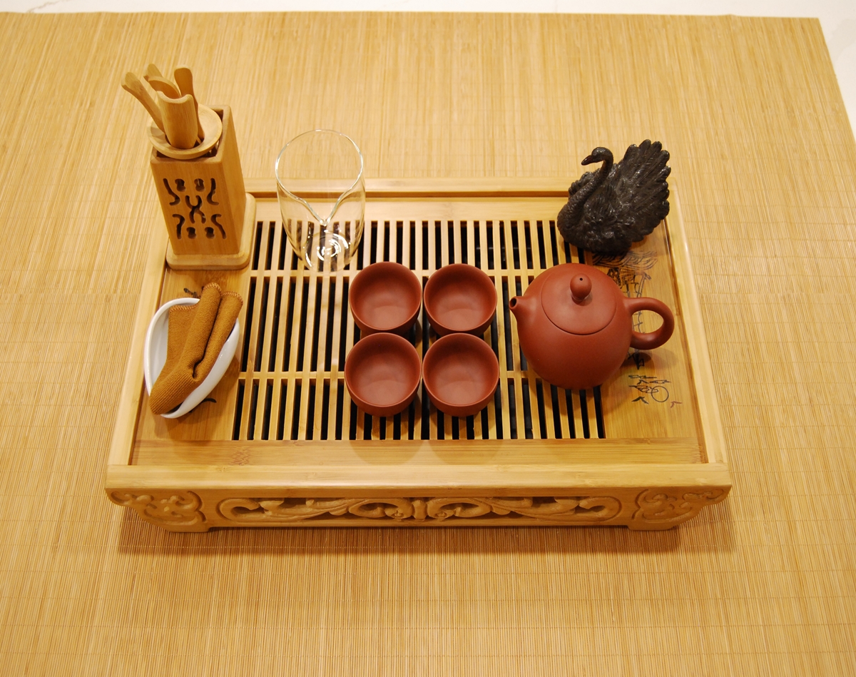 Ceremonial tea set with Yixing clay teapot, clay teacups, and bamboo tea tray