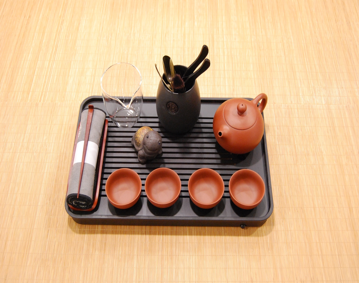Ceremonial tea set with Yixing clay teapot, cups, and bamboo tea tray