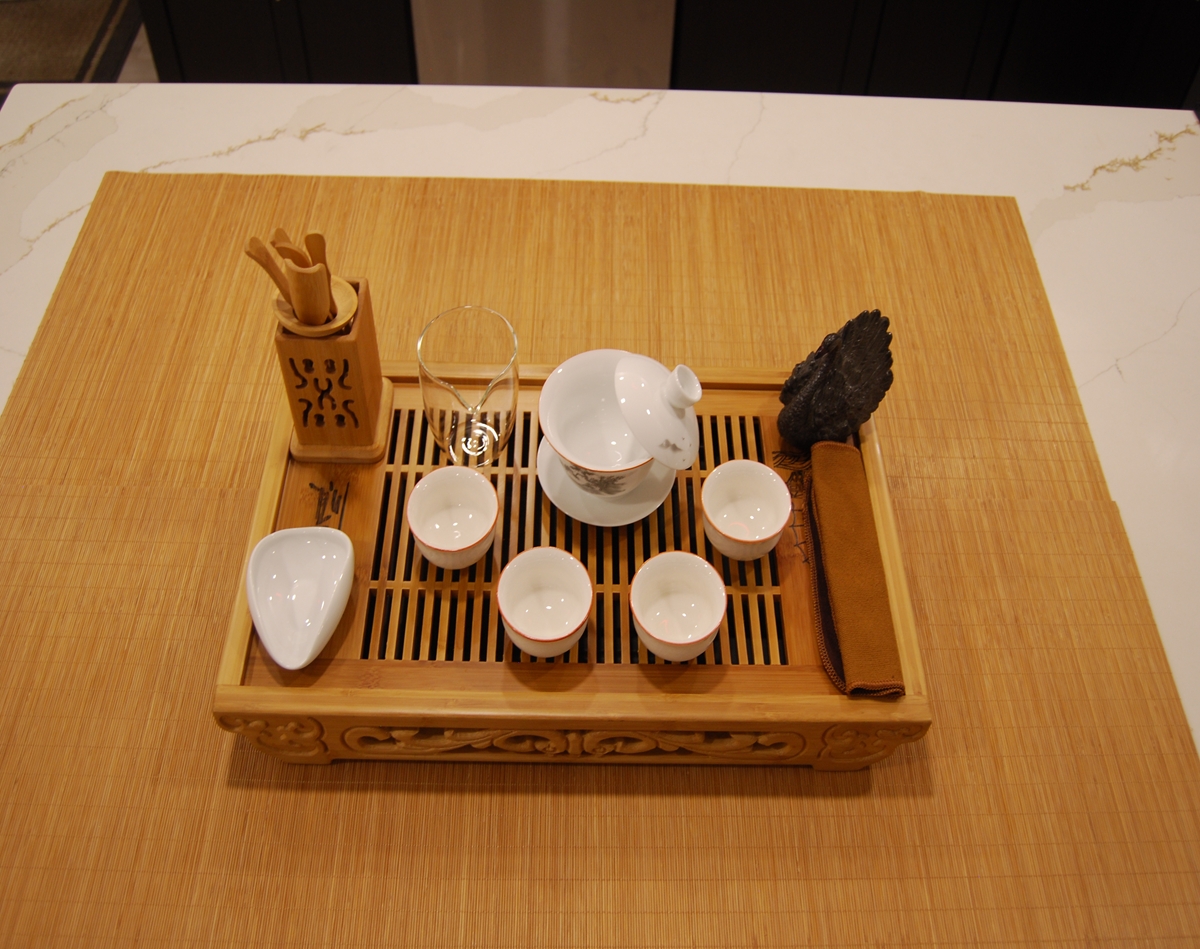 Ceremonial tea set with painted porcelain gaiwan, glaze cups, and bamboo tea tray