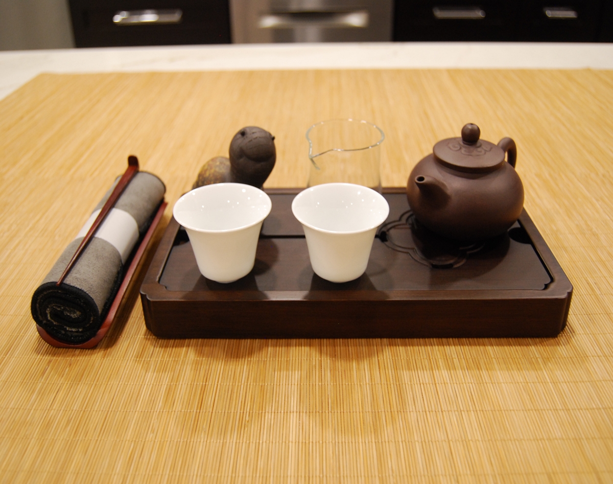 The Centered Ritual Set arranged for ceremonial tea practice with YiXing clay teapot, white porcelain cups, fairness cup, and dark tray