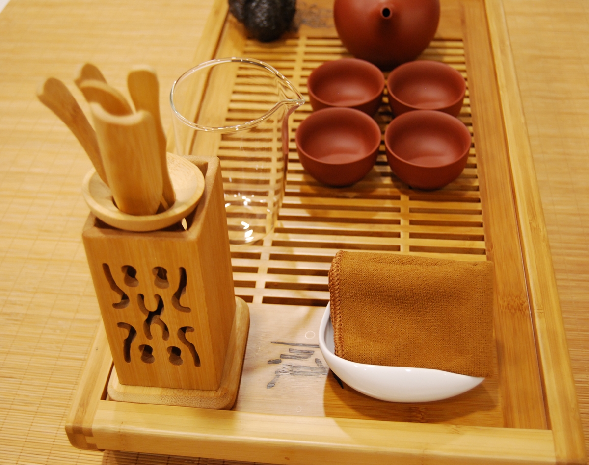The Deep Earth Ritual Set arranged for ceremonial tea practice with Yixing clay teapot, clay cups, fairness cup, and swan tea pet